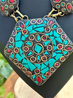 Vintage Tibetan turquoise and coral inlaid in brass. Adjustable length from 18"-20". Very nice vintage condition. Handmade Vintage Green Turquoise Necklace, Traditional Blue Patina Necklace, Traditional Turquoise Inlay Necklace As Gift, Traditional Turquoise Necklace With Inlay For Gift, Handmade Turquoise Brass Necklace, Unique Turquoise Brass Necklaces, Handmade Vintage Gold Turquoise Necklace, Vintage Handmade Turquoise Necklace In Gold, Vintage Turquoise Necklace For Festival