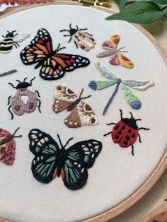 a close up of a embroidery with many different types of bugs and insects on it