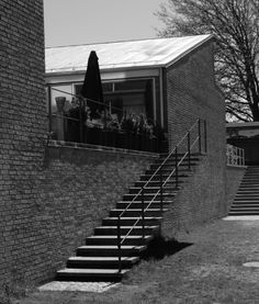 black and white photograph of stairs leading up to a brick building