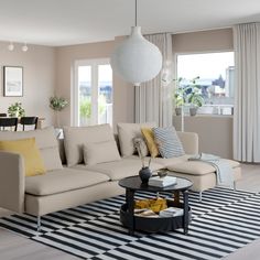 a living room filled with lots of furniture and decor on top of a black and white rug