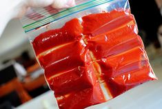 there are several pieces of red food wrapped in plastic wrapper on the counter top