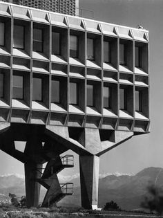 a tall building with multiple balconies on it's sides and stairs going up to the top