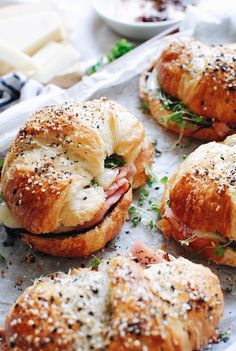 ham and cheese croissants on a tray with parsley sprinkled