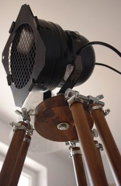 a close up of a camera on a tripod with two wooden poles attached to it