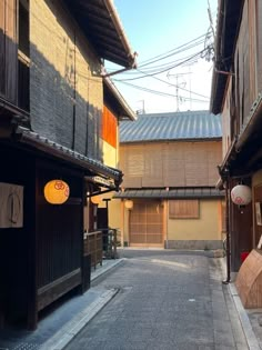 an alley way with wooden buildings on both sides