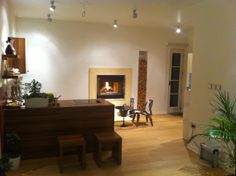 a living room filled with furniture and a fire place next to a wall mounted fireplace