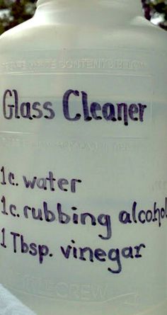 a glass cleaner bottle sitting on top of a window sill