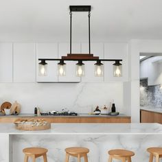 a kitchen with marble counter tops and wooden stools