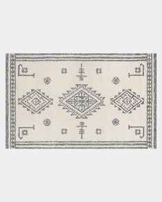 a white and blue rug with an intricate design on the bottom, in front of a gray background