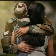 two people hugging each other in the middle of a photo with trees in the background