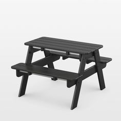 a black picnic table with two benches next to it on a white background in an empty room