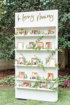 a white book shelf with photos and greenery on it that says, wedding memory