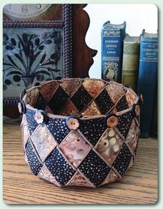 a basket sitting on top of a wooden table next to some books and a clock