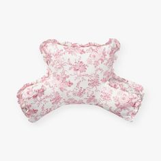 a pink and white flowered pillow on a white background