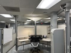 an office cubicle with desks and chairs