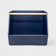 a blue planter with a wooden handle on the top and bottom, in front of a white background