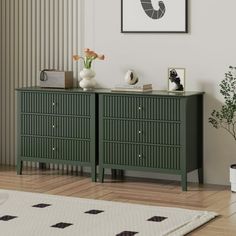 a living room with a green dresser next to a white rug and potted plant