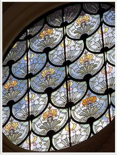 a round stained glass window with flowers on it