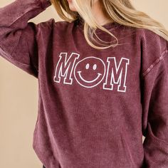 Maroon Corded Sweatshirt - Embroidered - Mom - (Smile) – Little Mama Shirt Shop LLC Relaxed Cotton Tops With Cozy Fit, Trendy Smiley Face Loungewear Tops, Trendy Smiley Face Tops For Loungewear, Relaxed Fit Embroidered Tops For Loungewear, Comfy Cotton Tops With Cozy Fit, Smiley Face Top For Loungewear, Relaxed Fit Smiley Face Top For Loungewear, Oversized Casual Tops With Embroidered Graphics, Cozy Fit Comfortable Cotton Tops