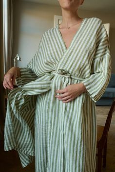 Linen robe designed for lounging routines. In full length, ¾ length dropped sleeves, and side seam pockets. Features a classic V-neck, and separate belt to delicately hug the body. This robe is crafted from natural and lightweight linen to ensure a breathable and soft experience. Cut in a relaxed shape, perfect to snuggle up with a morning coffee. SIZING AND FIT This garment is oversized. If you want to wear this piece as close-fitting, select a smaller size than you usually wear. Before placing Linen Robes, Linen Dressing Gown, Linen Nightgown, Linen Bathrobe, Linen Robe, Linen Shop, Womens Robes, Striped Linen, Sewing Clothes