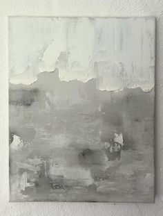 an abstract painting on a white wall with grey and white paint overlaying it