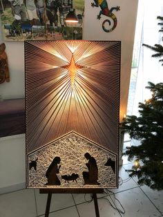 a nativity scene is displayed in front of a christmas tree