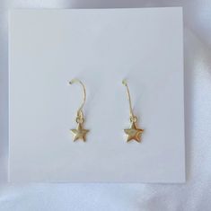 Add a hint of celestial charm to your look with our Dainty Star Charm Earrings! Featuring delicate star-shaped charms on gold or silver French wire hooks, these lightweight earrings are perfect for adding a touch of shimmer to your everyday style. Whether you’re strolling the beach or out for a night under the stars, these trendy earrings bring a subtle yet chic coastal vibe to any outfit. MATERIALS: gold: 14k gold plated brass base premium metal 18k gold-filled (hypoallergenic) silver: silver p Minimalist Star-shaped Tarnish Resistant Earrings, 14k Gold Filled Earrings With Star Charm As Gift, Everyday Star-shaped Tarnish Resistant Earrings, Tarnish Resistant Star-shaped Everyday Earrings, Everyday Star-shaped Tarnish-resistant Earrings, Everyday Drop Earrings With Star Charm, Star-shaped Earrings With Lever Back For Gifts, Dainty Star Charm Drop Earrings, Dainty Gold-plated Earrings With Star Charm