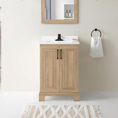 a bathroom with a sink, mirror and towel rack on the wall next to it