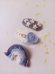 three crocheted hair clips laying next to each other on top of a table