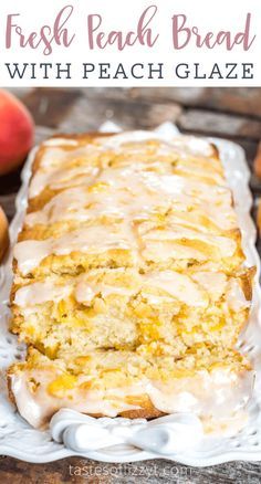 fresh peach bread with peach glaze on a white plate next to some peaches