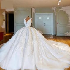 a white wedding dress on display in a room