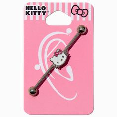 a hello kitty hair clip with a bow on it's head and two metal balls in the shape of a key