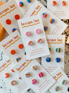 several pairs of lemon lee studs sitting on top of each other