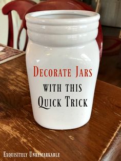 a white jar sitting on top of a wooden table