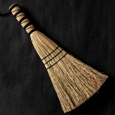 a broom is laying on a black surface