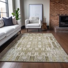 a living room with two white couches and a rug in front of a fireplace