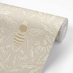 a beige and white wallpaper with a bee on it