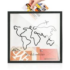 a person is holding up a paper cut out of the shape of a world map