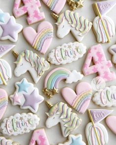 decorated cookies with unicorns, stars, and rainbows on top of a table