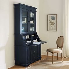 a desk and chair in a room with white walls, carpeted flooring and wooden floors