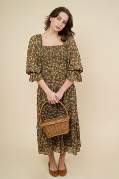 Romantic cottage core inspired midi dress in loose fit style. This dress comes in a cocoa brown that features a smocked bodice detailing with an allover mustard small flower print. Square ruffle neckline , 3/4 balloon sleeves with elastic cuffs. Slips on for wear Mother Friendly 100% Cotton Hand Wash Cold / Line Dry Measurements & Fit Notes Olivia and Rosa are both wearing a size Small Casual Brown Midi Dress With Smocked Back, Casual Billowy Midi Dress With Smocked Cuffs, Fall Floral Print Smocked Dress For Daywear, Spring Brown Midi Dress With Square Neck, Spring Midi Dress With Square Neck In Brown, Fall Flowy Smocked Dress With Gathered Sleeves, Brown Puff Sleeve Midi Dress For Brunch, Brown Midi Dress With Smocked Bodice For Brunch, Brown Smocked Bodice Midi Dress For Brunch