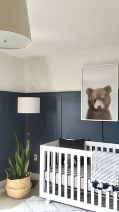 a baby's room with blue walls and white crib