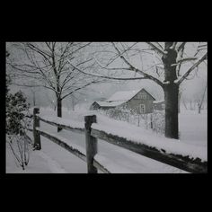 a black and white photo of a snow covered fence