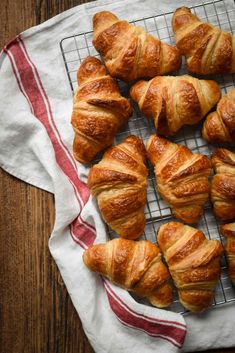 freshly baked croissants on a cooling rack, ready to be eaten for breakfast