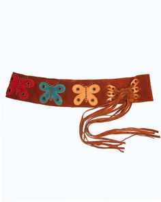 Multi-colored butterfly overlays and studs add a cute, boho touch to this suede leather tie belt. The contour shape makes it easy to wear loosely around the hips or use to cinch in the waist with the adjustable ties! 3.25" width Size S/M 32"-36" 20" tie length Genuine Leather- Tan Suede, multi colored butterflies Copper Studs Made in the USA **Vintage Sample, from early 2000's, a few tiny scratches on suede Adjustable Corset Belt With Belt Loops For Festivals, Adjustable Corset Belt For Festivals, Adjustable Brown Belt For Festival, Adjustable Brown Belts For Festival, Bohemian Brown Belt For Festival, Vintage Brown Corset Belt For Festivals, Brown Leather Corset Belt For Festivals, Tie Belt Outfit, 70s Belts