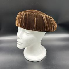 Step back in time with this vintage 1940s hat, ideal for channeling your inner retro diva. Perfect for topping off any outfit with a touch of nostalgia, it's like a small, stylish spaceship for your head. Wear it and wait for compliments to land! * Vintage 1940s style   * Chic shape   * Luxurious fabric   * Ruched detailing   * Elegant brown color Some discoloration and tiny stains. There is one worn spot. Please see the pictures for the full description. 1940s Hats, Hat Fascinator, 1940s Style, Pillbox Hat, Head Wear, Pill Boxes, 1940s Fashion, Style Chic, Luxury Fabrics