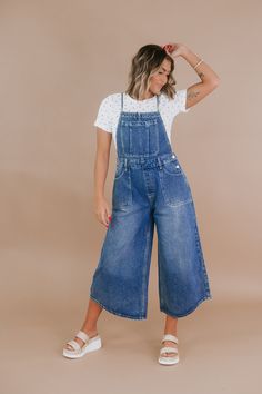 Make a bold style statement with the OLI & HALI: Denim Overall. This trendy piece combines comfort and fashion in an effortlessly chic design. Dress it down with sneakers for a laid-back look! Denim Overalls Adjustable straps Elastic on the sides of the waist Functional Pockets Spaghetti straps MEASUREMENTS:S: INSEAM: 24” | RISE: 12.25”M: INSEAM: 24.5” | RISE: 12.5”L: INSEAM: 25” | RISE: 12.75”XL: INSEAM: 25.5” | RISE: 13” Model Specs: Emily is wearing a size small in the photo.How will this ite Casual Denim Jumpsuit For Workwear, Casual Medium Wash Denim Jumpsuit For Work, Casual Denim Jeans For Work, Spring Utility Style Medium Wash Denim Jumpsuit, Casual Denim Blue Jumpsuit For Work, Spring Utility Jeans For Everyday, Everyday Dark Wash Cotton Denim Jumpsuit, Spring Utility Denim Jumpsuit, Spring Elevated Casual Denim Jeans