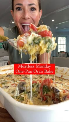 a woman is taking a bite out of a cheesy casserole dish