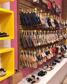 shoes are lined up on shelves in a store