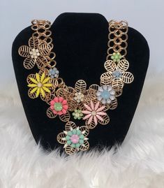 Statement Necklace with flower accents in various colors. Trendy Multicolor Flower Shaped Jewelry, Spring Chic Jewelry With Flower Decoration, Chic Spring Jewelry With Flower Decoration, Spring Flower Jewelry With 3d Flowers, Spring Flower Shaped Jewelry With 3d Flowers, Bohemian Jewelry For Spring Party, Handmade Flower Necklaces For Party, Party Necklaces With Handmade Flowers, Multicolor Flower Necklace With Flower Decoration